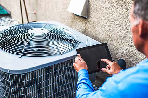 What is a TM44 inspection. An AC inspector working on a roof mounted unit